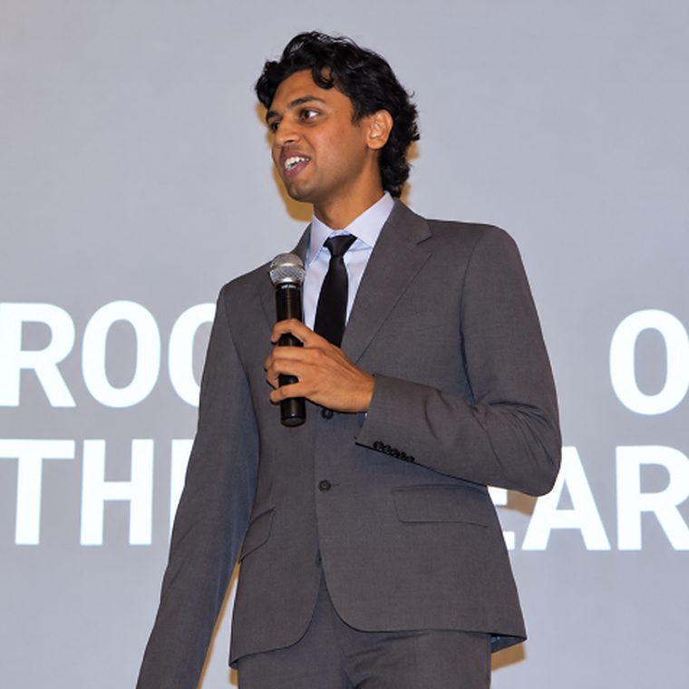 Rishe Paridas speaking on stage, 2026 Golden Door winner